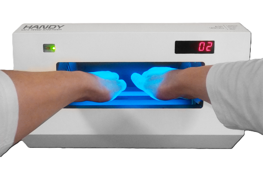 Hands positioned inside the illuminated HANDY chamber